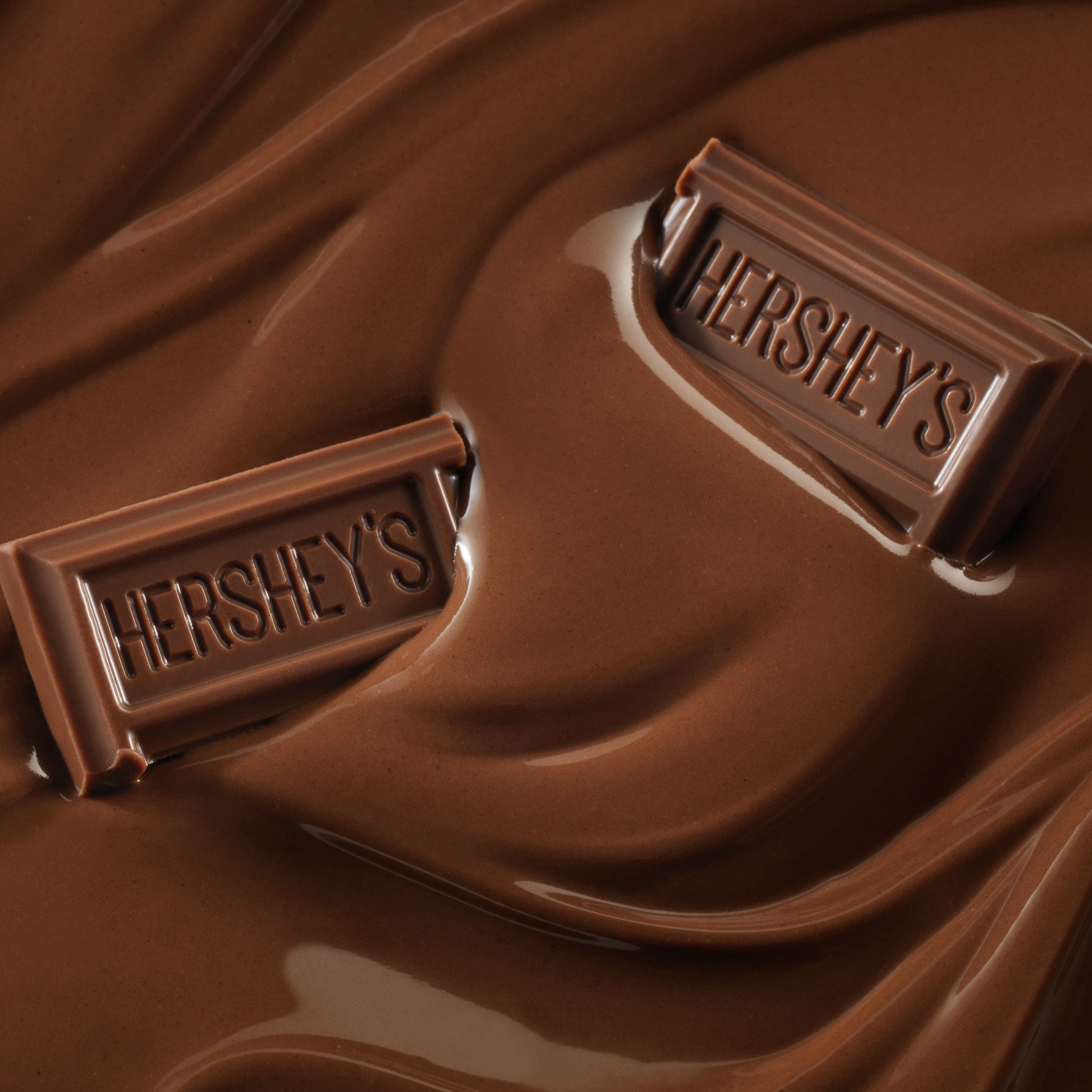 Dois pedaços de chocolate Hershey's em cima de um creme de Hershey's ao leite.